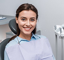 Woman sitting in dental chair smiling