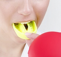 person wearing a yellow mouthguard