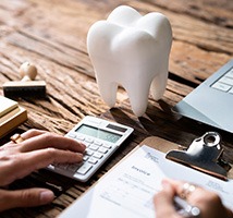 A patient calculating the cost of dental crowns