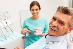 Smiling senior man in dental chair