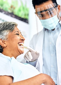 Dentist showing patient their smile in reflection