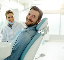 Man smiling while sitting in dental chair