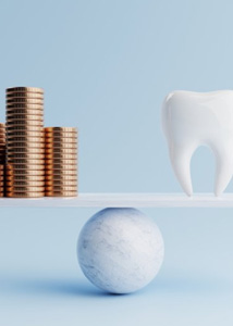 Tooth balanced against coins