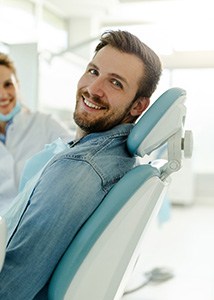 Happy male dental patient looking over his shoulder