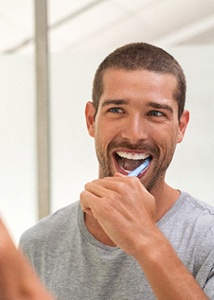 man brushing his teeth