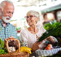 senior couple buying fruits and vegetables