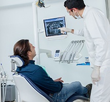 Patient and dentist discussing the cost of dental implants in Jonesboro