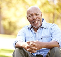 Man smiling after saving money on dental implants in Jonesboro 