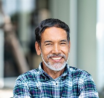 Man with dental implants in Jonesboro, AR standing outside