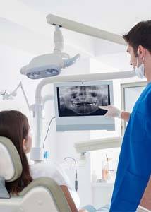 dentist explaining dental implant post-op instructions in Jonesboro