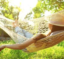 Patient resting in hammock while recovering from dental implant surgery in Jonesboro