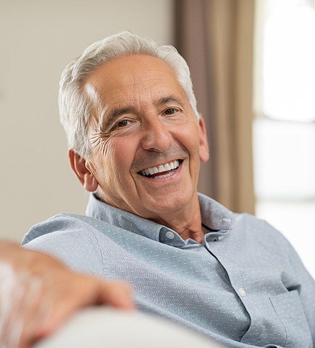 man smiling with dental implants