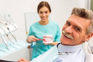 Smiling senior man in dental chair