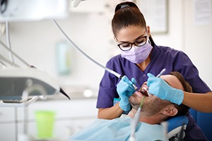 a dental hygienist cleaning a patient’s teeth