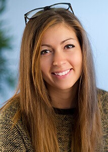 Woman with long light brown hair smiling