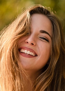 closeup of woman smiling outside 