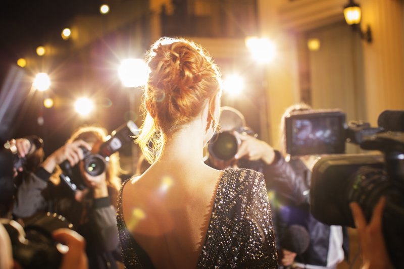 Celebrity showing her dental implants in Jonesboro to paparazzi