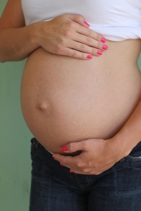 Pregnant woman holding her belly